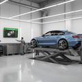 Car on alignment rack with laser sensors on front wheels, alignment machine screen showing green measurements